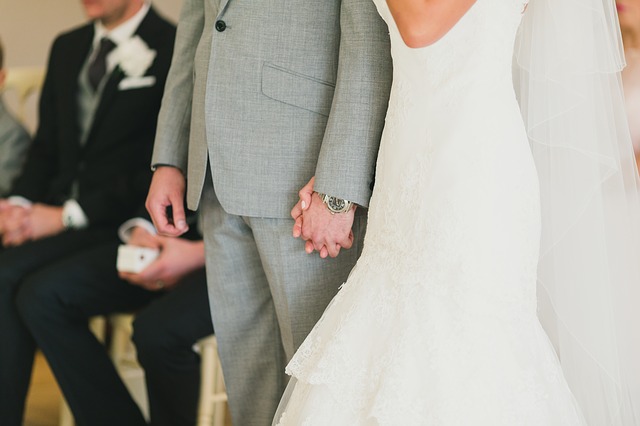 couple holding hand in wedding